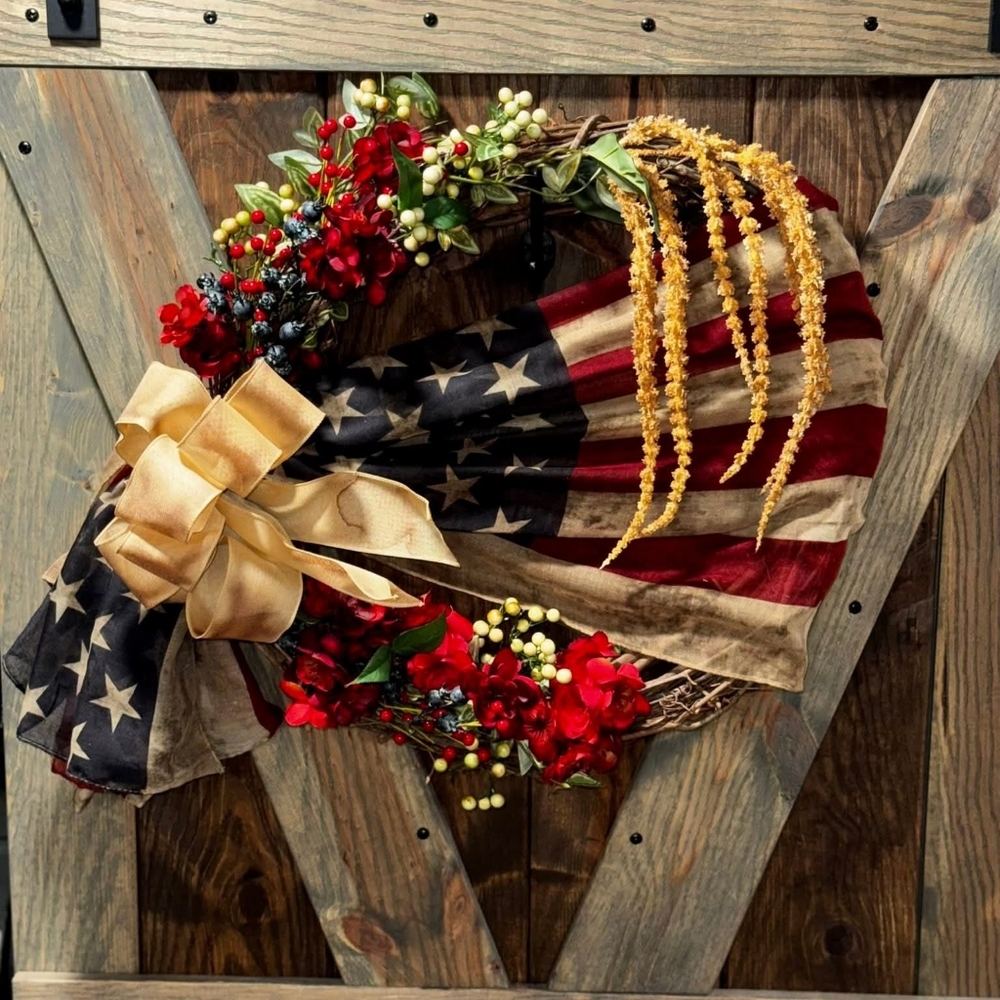 Patriotic Flag Wreath with Red Blooms and Gold Bow